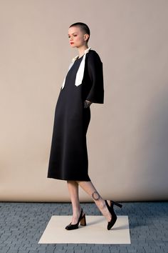 "With this beautiful Minimalist Dress we introduce our fashion for Spring 2019 ! This stylish black dress is cut in the the brand's most recognizable silhouette - the laid-back approach to elegance. The design has straight, elegant silhouette - it is our go-to for effortless, easy-to-wear pieces. Wear your occasion dress with sandals, high heels, ballerinas. ITEM DETAILS: - straight line - side pockets - shoulder bow decorations - custom orders: yes - color: black and creamy COMPOSITION AND CARE Black A-line Dress For Office Wear, Modern Black Midi Dress For Party, Black Office Lady Dress For Workwear, Modern Black Midi Dress For Cocktail, Modern Black Midi Dress For Evening, Black Sheath Office Dresses, Black Office Lady Dress For Work, Black Sheath Dresses For Office, Black Sheath Midi Dress For Office