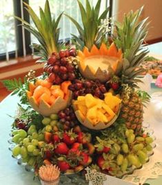 a table topped with lots of different types of fruits and veggies on top of each other