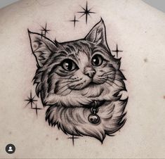 a cat tattoo on the back of a woman's upper arm and chest, with stars in the background