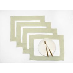 four placemats with gold forks on them