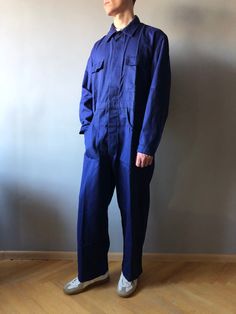 Workwear Pants / Work Coveralls / French Chore Pants / French Workwear / Size M-L This vintage coveralls in good unuse condition, dark spots left from storage (last photo) - made in Belgium - color - Navy Blue - 4 front pockets  - 1 back pockets - 2 cuff steel buttons - 7 steel buttons at front - material - sanforized cotton - label size - 52 (fit size M/L, watch measurements) FLAT Measurements: Shoulders : 51cm Chest (underarm to underarm) : 59cm Sleeve : 64cm Length(back) : 90cm Waist : 55cm + Cotton Overalls With Pockets For Work, Long Sleeve Overalls With Side Pockets For Fall, Cotton Utility Overalls, Utility Cotton Overalls Pants, Cotton Full-length Relaxed Fit Overalls, Retro Relaxed Fit Overalls With Pockets, Cotton Overalls With Relaxed Fit, Vintage Cotton Overalls With Side Pockets, Cotton Full Length Relaxed Fit Overalls