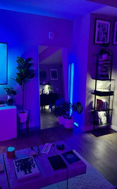 the living room is lit up with purple and blue lighting, while the television is on