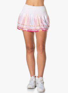 Bring some contemporary flair to your game in this smocked waist band skirt. Featuring a sporty border stripe for a pop of color and done in a wet shimmer finish that let’s you shine under the sun or the lights. Sporty Skirted Swim Skirt For Spring, Sporty Swim Skirt For Spring, Pink Casual Tennis Skort, Spring Sports Swim Skirt With Elastic Waistband, Pink Skirt With Smocked Back For Summer, Pink Tennis Skort For Spring, Pink Tennis Bottoms For Summer, Casual Multicolor Swim Skirt For Spring, Sporty Pink Skirted Bottoms