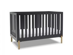 a black crib with white sheets on the bottom, and wooden legs in front