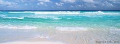 an ocean view with waves crashing on the shore and blue sky above it, as well as white clouds in the distance