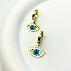 Our Mystic Blue Evil Eye Hoops are designed to impress with their high polish finish and secure hinged closure. These beautiful earrings are available in gold and silver, providing protection and warding off negative energy with their eye-catching design.Available in gold and silver. Blue Evil Eye, Custom Earrings, Custom Bracelets, Custom Necklace, Negative Energy, Custom Rings, Gold And Silver, Ring Necklace, Evil Eye