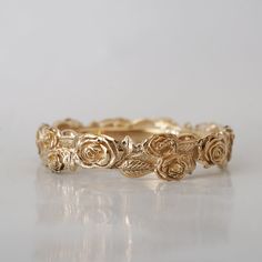 a gold ring with roses on it