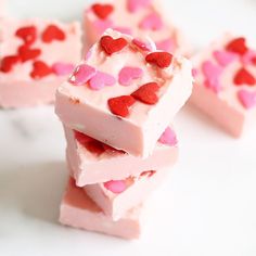 two - ingredient strawberry fudge candy bars stacked on top of each other with pink and red hearts