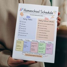 a person holding up a poster with the words homeschool schedule written on it