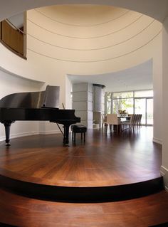 a grand piano sitting on top of a hard wood floor