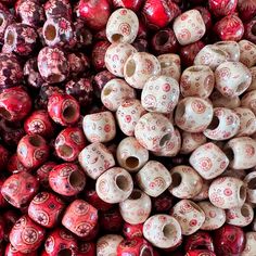 many red and white ceramic beads are stacked on top of each other