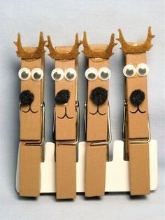 three cardboard reindeers are standing next to each other with their noses painted brown and white