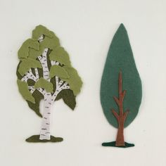 two pieces of paper cut out to look like trees