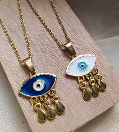 evil eye necklacefortune tellergood luck necklaceevil eye gold charmevil eye golddainty gold necklacegold eye pendantgifts for herdainty necklaceDelicate NecklaceBirthday giftgold necklacelayered necklace Evil eye charm pendant is made of 24k gold plated steel and is handpainted! Customize your necklace by choosing the length of it (35 - 85 cm) and between 2 Evil eye colors! Everything is handmade from the scratch with love and care. All the parts are waterproof,nickel free and antiallergic . Ev Gold Evil Eye Pendant Charm Necklace, Gold Evil Eye Necklace As Gift, Gold Dangle Jewelry With Evil Eye, Spiritual Gold Eye-shaped Necklace, Gold Plated Evil Eye Pendant Charm Necklace, Adjustable Teardrop Evil Eye Jewelry, Gold Plated Evil Eye Charm Necklace Gift, Gold Dainty Evil Eye Charm Necklace, Gold Dainty Jewelry With Evil Eye