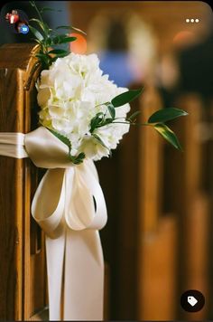 a bouquet of white flowers sitting on top of a pew