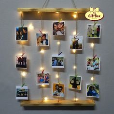 a wooden shelf with pictures and lights hanging from it