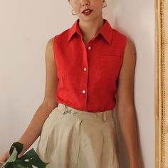 Vintage minimalist button-up shirt in a rich red shade. A beautiful classic sleeveless shirt! Collared with one chest pocket and mother of pearl button up fastening. Light weight, comfortable, and with a long length. Perfect for your everyday summer looks. BRAND: Times MATERIAL: 55% linen, 45% cotton **CONDITION: Excellent Vintage Condition **MEASUREMENTS: UK 10 / US 6 / EU 38 Our model's size is Small (UK 10, US 6, EU 38) NOTE: Our size recommendation is a guide only. Please refer to the measur Red Collared Blouse With Pockets, Solid Sleeveless Shirt For Summer, Red Summer Tops With Pockets, Red Workwear Shirt With Pockets, Vintage Red Sleeveless Top, Red Work Shirt With Pockets, Classic Sleeveless Buttoned Blouse, Classic Sleeveless Blouse With Buttons, Classic Red Sleeveless Top