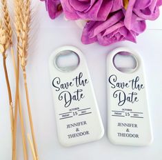 two white bottle openers with the words save the date on them next to some flowers