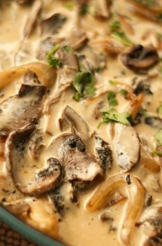 a close up of a bowl of food with mushrooms and broccoli on it