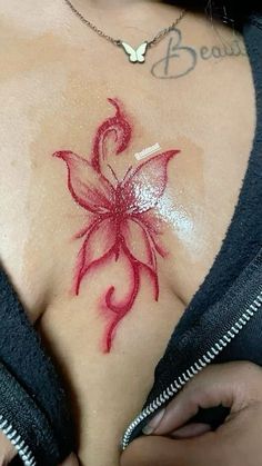 a woman's chest with a flower tattoo on it