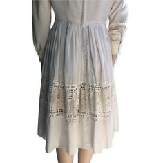 "Here I have a lovely cream dress made by Lou Ross of California in the 1950s.  It features a fine semi transparent pleated skirt with a panel of lace roses around the mid skirt.  Some of the lace has come away in the back please see photos priced accordingly.  This dress has long sleeves which may have been added by the previous owner.  Metal zipper in great working condition. Diamond lace panel around the neckline. One small mark on the back, all in all this is a really sweet dress.  No sizing Beige Lace Trim Midi Dress For Garden Party, Beige Midi Dress With Lace Trim For Garden Party, A-line Vintage Dress With Lace Trim, Knee-length Cream Dress With Lace Patchwork, Beige A-line Midi Dress With Lace Trim, Casual Cream Midi Dress, Feminine Vintage Midi Dress With Lace Trim, Vintage Midi Dress For Casual Occasions, Cream Midi Dress With Lace Trim For Garden Party