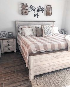 a bed sitting in a bedroom on top of a wooden floor next to two nightstands