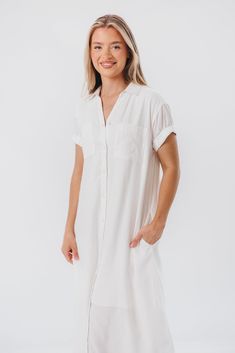 This midi dress just feels summer-ready. The Paris Shirt Dress features a classic collared neckline, with easy short sleeves and a flowy fit that will be an instant favorite. Add a belt and mules and you've aced everyday glamour. FIT: Runs true to size - relaxed fit. MATERIAL: 55% Linen, 45% Viscose. Machine wash cold. GARMENT DETAILS: Linen-blend shirt dress with collared V-neckline, button front placket, and chest pockets. Features cuffed short sleeves and in-seam side pockets. SIZE GUIDE: XS Paris Shirt, Garment Details, Nursing Friendly, Cuffed Shorts, Midi Shirt Dress, Summer Ready, Linen Blend, Size Guide, Shirt Dress