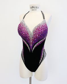 a woman's leotard with purple and silver sequins on it