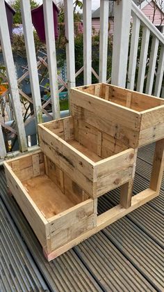 two wooden boxes sitting on top of a deck next to each other and one is empty