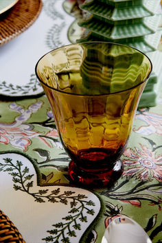 a glass bowl sitting on top of a table covered in plates and napkins,