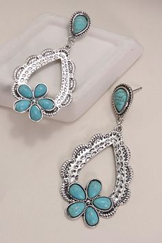 Western Turquoise Flower Drop Earrings, a stunning blend of Western charm and timeless elegance. These earrings feature intricately crafted turquoise flowers suspended from delicate drops, capturing the essence of the Southwest with a touch of sophistication. ??Each earring showcases the beauty of turquoise stones in a floral motif, evoking the rugged beauty of the Western landscape. Whether you're exploring the open range or stepping out for a night on the town, these earrings are sure to make Bohemian Blue Teardrop Flower Earrings, Blue Bohemian Teardrop Flower Earrings, Blue Teardrop Bohemian Flower Earrings, Turquoise Dangle Earrings With Flower Charm, Turquoise Flower-shaped Jewelry With Matching Earrings, Bohemian Turquoise Flower Shaped Jewelry, Bohemian Turquoise Flower-shaped Jewelry, Turquoise Flower Charm Dangle Jewelry, Turquoise Dangle Jewelry With Flower Charm