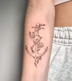 a woman's arm with an anchor tattoo on it