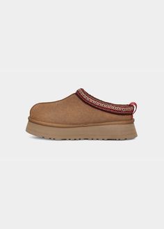 A plush boost takes cozy looks to the next level in the chunky platform and inspired design of the Tazz slip-ons from UGG®. 1-3/4" heel; 1-1/2" platform Round-toe slip-on platform flats UGG® Tasman braid detail at trim UGGplush™ lining and insole Suede/fabric (70% recycled) upper; polyester (70% recycled)/rayon braid; polyester (100% recycled) binding; wool (80% upcycled)/lyocell lining and insole; manmade sole Imported Ugg Tazz Platform, Tazz Slippers, Ugg Tazz, Closed Toe Heels, Ugg Tasman, Platform Flats, Platform Slippers, Suede Fabric, Purse Strap