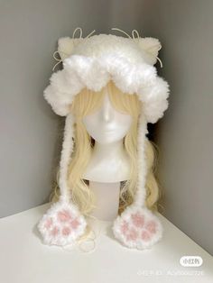 a wig and hat on top of a white mannequin head