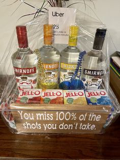 a clear box with liquor bottles in it and a sign that says you miss 10 % off the shots you don't take