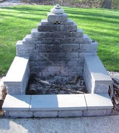 an outdoor fire pit made out of cinder blocks