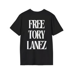 Show your support with this graphic tee featuring an image of rapper Tory Lanez on the front and a powerful 'Free Tory Lanez' message on the back. Crafted from premium cotton for a comfortable fit, this shirt combines bold style with a meaningful statement. The unisex soft-style t-shirt puts a new spin on casual comfort. Made from very soft materials, this tee is 100% cotton for solid colors. Heather colors and sports grey include polyester. The shoulders have twill tape for improved durability. Edgy T-shirt For Fan Merchandise With Logo Print, Edgy Letter Print T-shirt For Fans, Edgy T-shirt With Logo Print For Concerts, Graphic Tee With Logo Print For Concert, Edgy Concert T-shirt With Logo Print, Edgy T-shirt With Logo Print For Fan Merchandise, Graphic Tee With Back Print For Concert, Urban Style Concert T-shirt With Logo Print, Relaxed Fit Letter Print T-shirt For Concerts