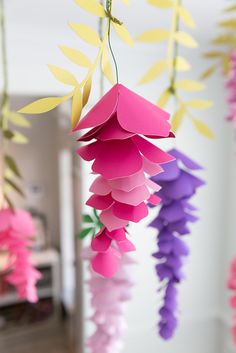 some paper flowers hanging from the ceiling