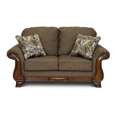 a couch with two pillows on it and some wood frame around the armrests