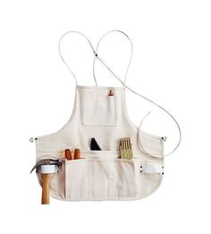 an apron with tools hanging from it's pockets on a white background for use as a tool holder