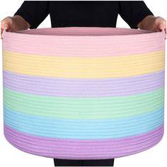 a person holding a large rainbow colored basket