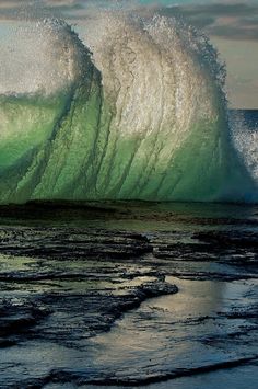 a large wave is breaking on the beach