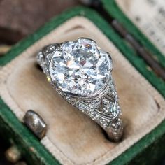 an antique diamond ring sits in a box