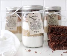 three jars filled with brownies next to each other