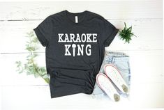 a t - shirt with the words karaoke king on it next to some shoes