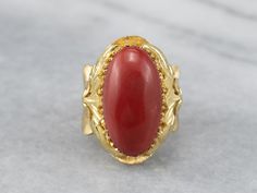 This is a beautiful, Victorian-inspired piece! Organic forms of textured 18k gold frame the deeply saturated coral, while the multi-prong setting holds the cabochon safely in place. The polish on this sumptuous coral is excellent, and makes this ring elegant enough for evening wear! Metal: 18K Yellow Gold Gem: Coral Gem Measurements: 19.4 x 10.4 mm, Oval Ring Size: 6.75 Marks: "750" Stamped on the inside band Elegant Coral Rings For Anniversary, Formal Coral Jewelry With Cabochon Details, Formal Coral Jewelry With Cabochon, Unique Cabochon Ruby Ring For Formal Occasions, Coral Elegant Wedding Rings, Elegant Coral Wedding Rings, Elegant Red Dome Ring For Formal Occasions, Red Coral Ring, Ring Elegant