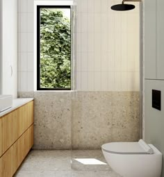 a bathroom with a white toilet sitting next to a window in the middle of it