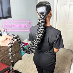 Knee length braids on black women Dramatic Braided Ponytail, Distressed Braided Ponytail, Passion Braid Ponytail, Ponytail Slick Hairstyles, Mid Ponytail Braid, Two Ponytails With Weave Braids, Swoop Braided Ponytail For Black Women, Two Ponytail Braids, Sleek Ponytail Braid