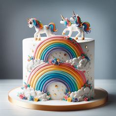 a white cake decorated with rainbows and clouds