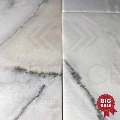 white marble tile with red seal for sale on the corner of a kitchen countertop